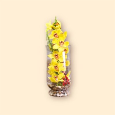 tall glass vase filled with yellow orchids and red berries