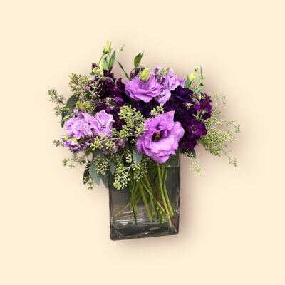 Purple flower arrangement in a glass vase.