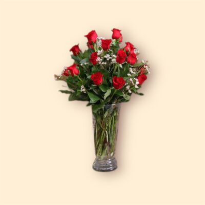 two dozen red roses in a glass vase