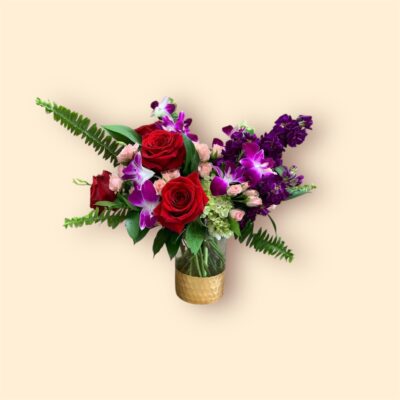 bouquet of red and purple flowers in a clear vase