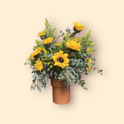 sunflowers and greenery in a terra cotta pot