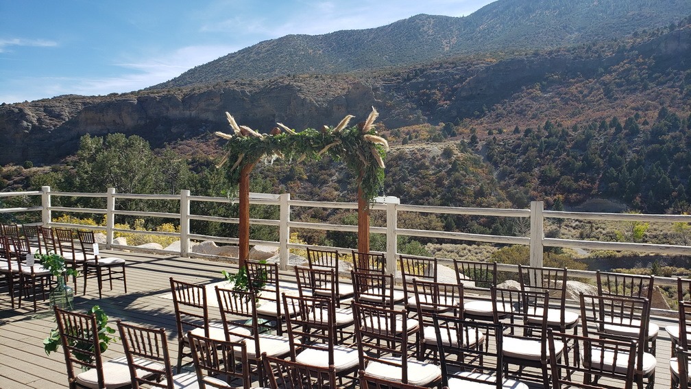 decorated wedding ceremony with flower arch outdoors