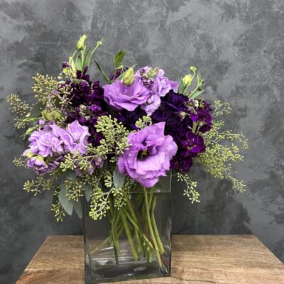 purple flower arrangement in a glass vase