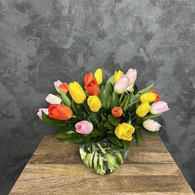 group of tulips in a glass vase