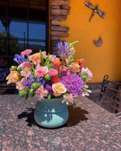 vase full of flowers on a table outside