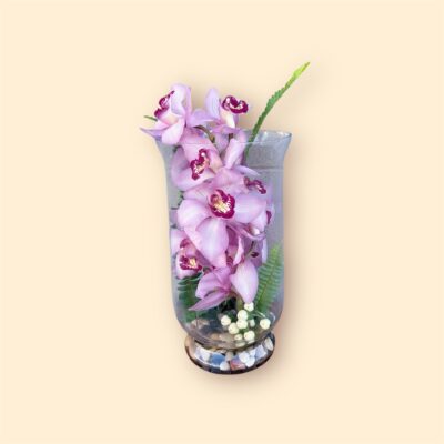 pink orchids stacked in a clear vase