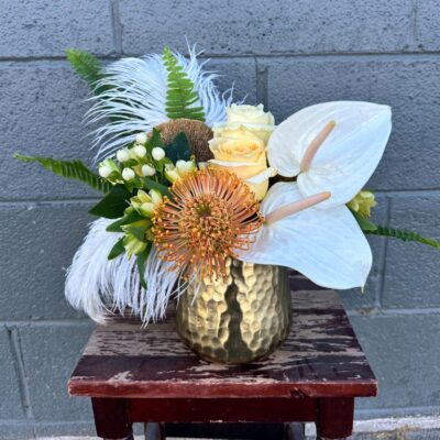 desert theme flower bouquet in white and yellow flowers with a gold vase